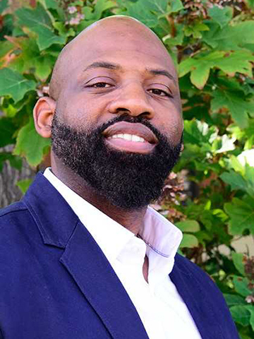 A photo of Christopher Tinson, Ph.D., director of the African American Studies program at SLU.