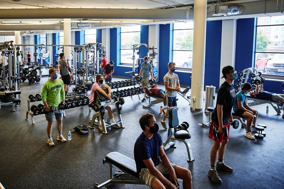 Students lift weights and social distance at the Simon Recreation Center.
