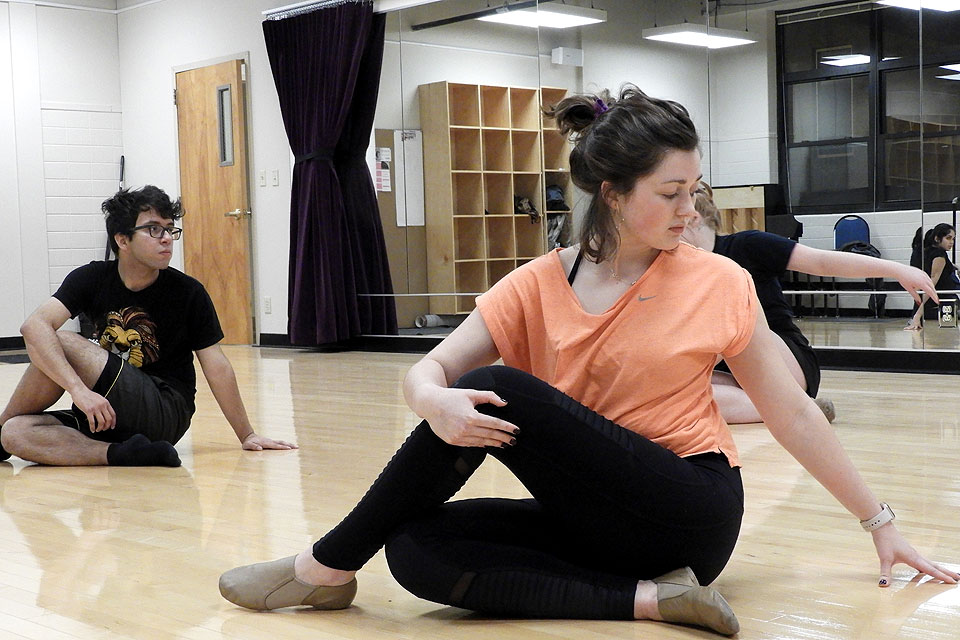 Sophomore Reed McLean (front) stretches during a Make Dark Days Brighter movement class.