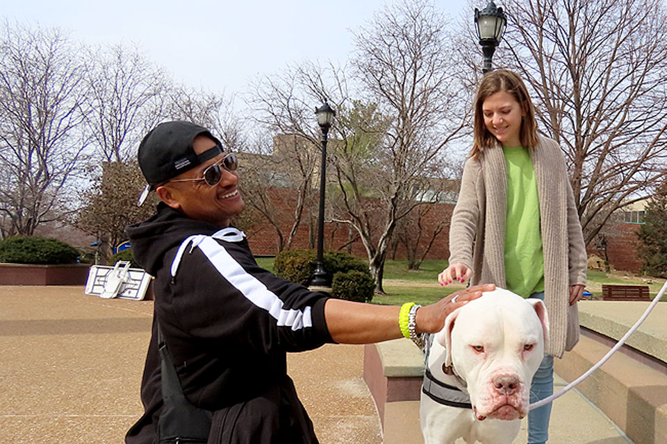 Students pet Hoonah during a March 2020 Yappy Hour.