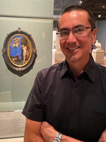 John Encarnacion, Ph.D., stands near a favorite piece at the Saint Louis Art Museum.