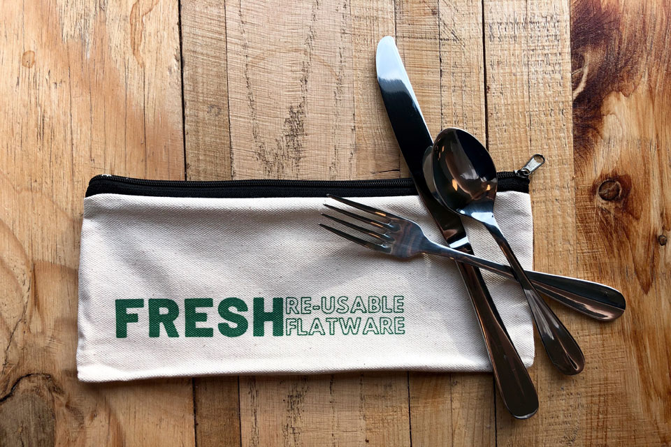A Fresh Gatherings reusable flatware kit with knife, spoon, fork and canvas bag.