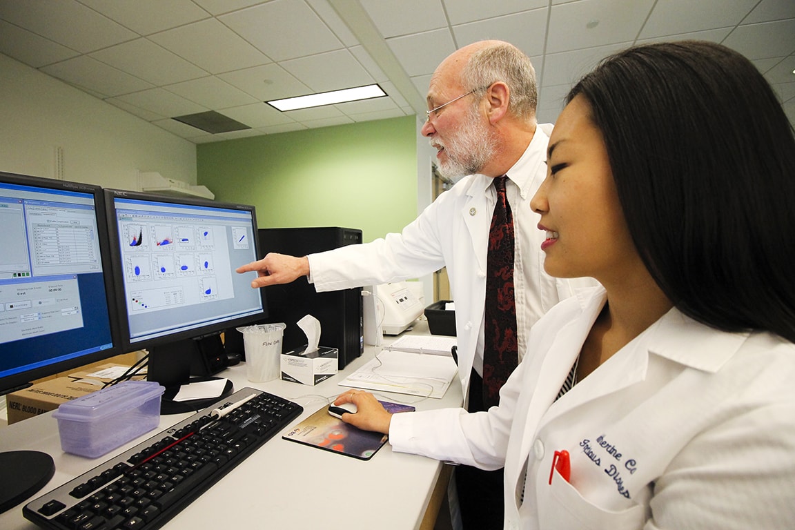 Daniel Hoft, M.D., Ph.D., and Catherine Cai review data about T cells.