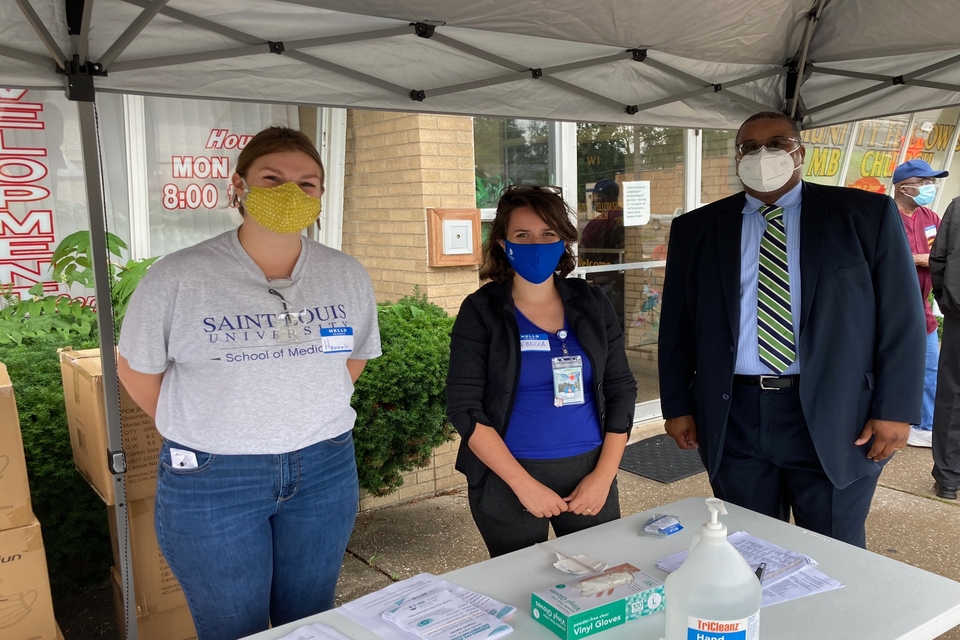 (From left) Second-year SLU medical students Hannah Gaynier and Rebecca Cunningham join Rev. Rodrick K. Burton at the distribution and registration table during the Aug. 1 Personal Protectice Equipment (PPE) distribution event at New Community Fellowship Missionary Baptist Church (NCFMBC) in Jennings, Missouri. Submitted photo