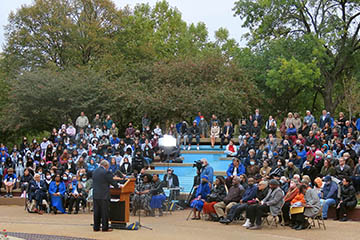 SLU Trustee Darryl Jones (’77) addresses a large crowd gathered at the clock tower for the Dr. Jonathan C. Smith Amphitheater dedication event Oct. 25.