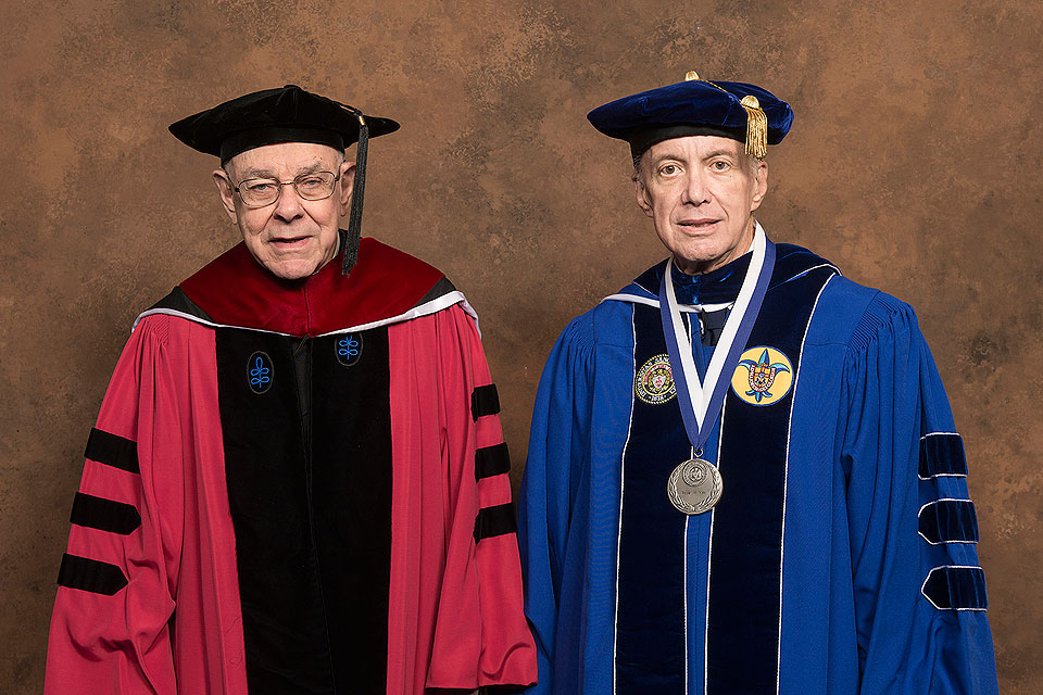 Robert May (right) presented John Padberg, S.J., with an honorary degree at SLU’s commencement May 20, 2017, at Chaifetz Arena.

