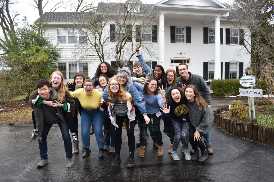 A group of Micah students clown and pose for a photo at their Faith Action Retreat.