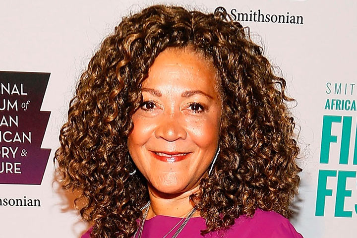 Smiling female radio reporter with thick curly hair