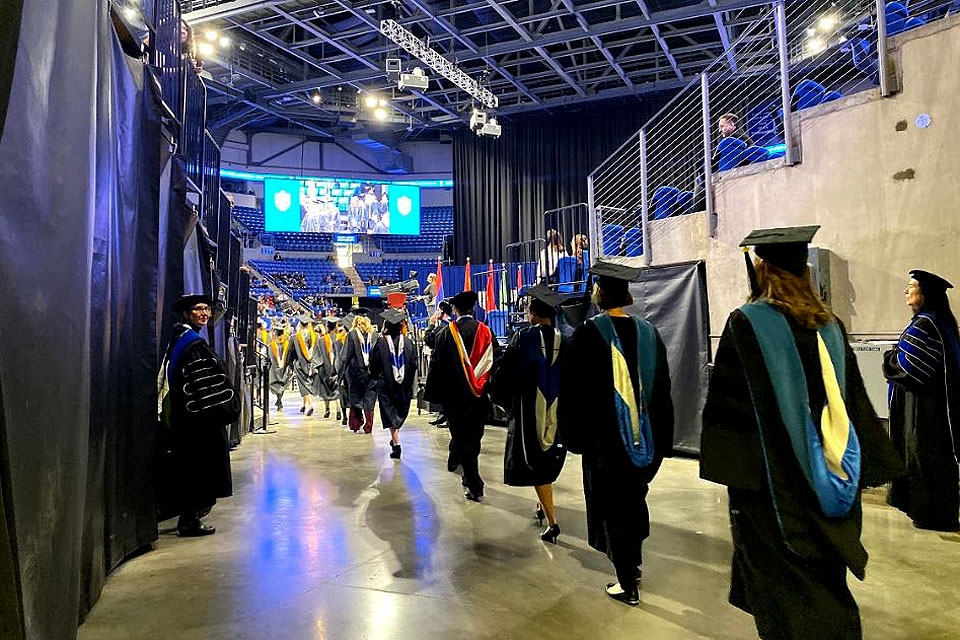 New graduates begin the procession at mid-year commencement.