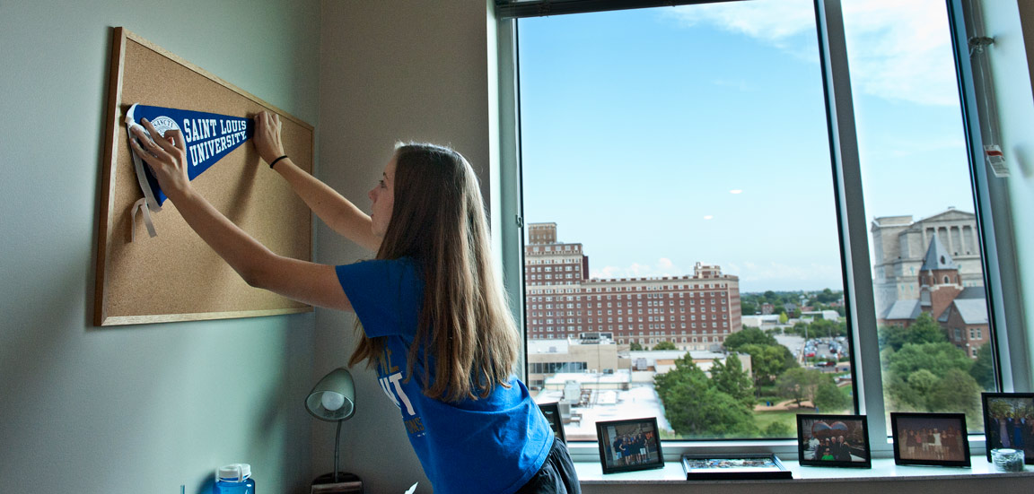 Freshman Shannon Keaveney decorates her new room in Spring Hall.