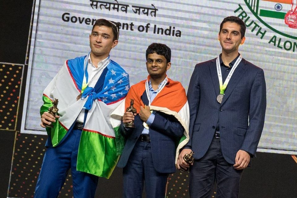 SLU chess team member Nikolaos Theodorou, right, is pictured with, from left, Nodirbek Yakkuboev, bronze (Uzbekistan) and Nihal Sarin, gold (India). Yakkuboev and Sarin pose with their respective flags draped on their shoulders.