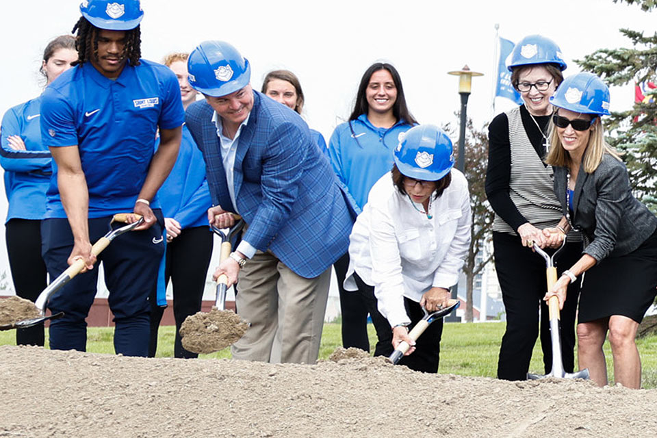 A photo of members of the SLU community breaking ground on the new O’Loughlin Family Champions Center.