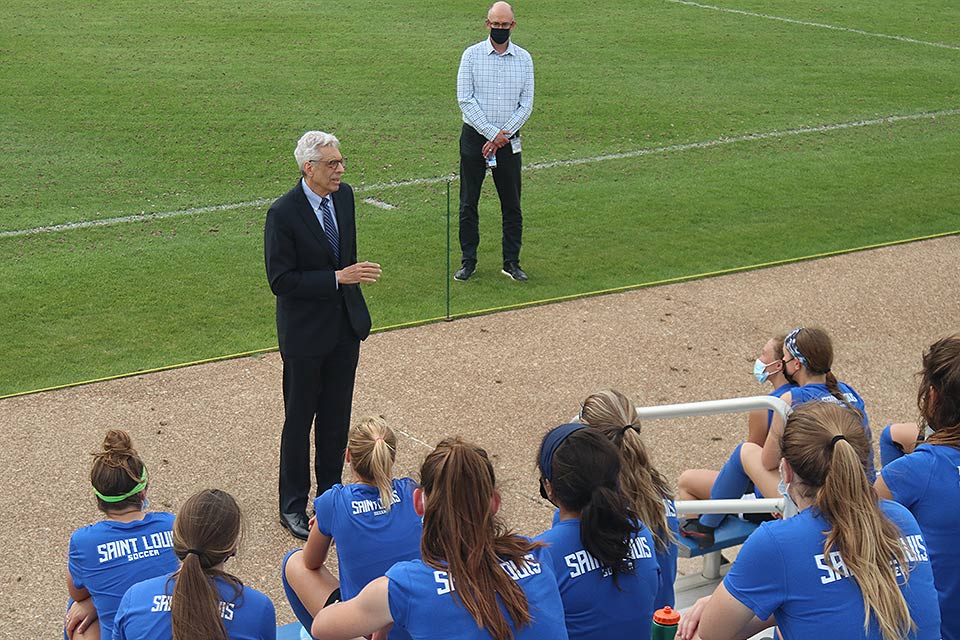 SLU President Fred P. Pestello, Ph.D., speaks to the women's soccer team.