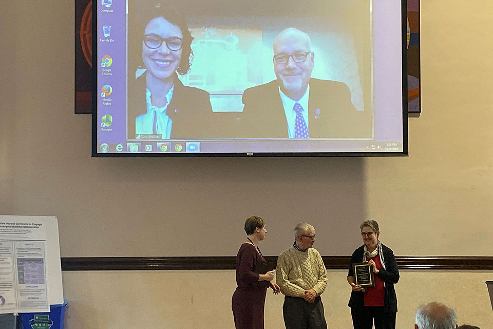 SLU faculty members Ginge Kettenbach, Ph.D. (left) and Anthony Breitbach, Ph.D. (onscreen, left) receive the 2019 James H. Korn Scholarship of Teaching and Learning Award. Submitted photo