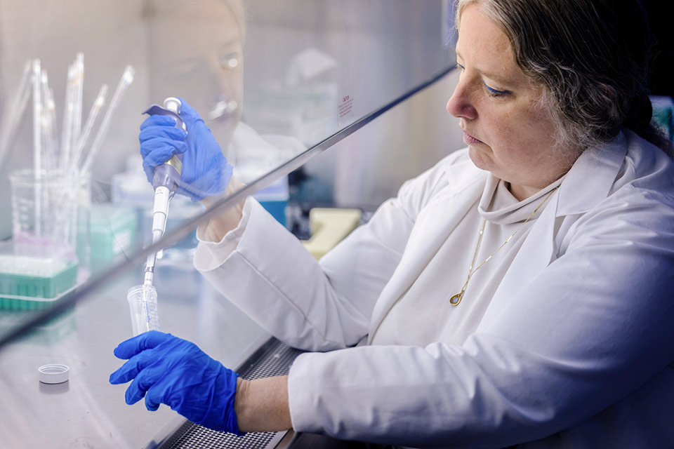 Sarah George, M.D., professor of infectious diseases, works in a lab