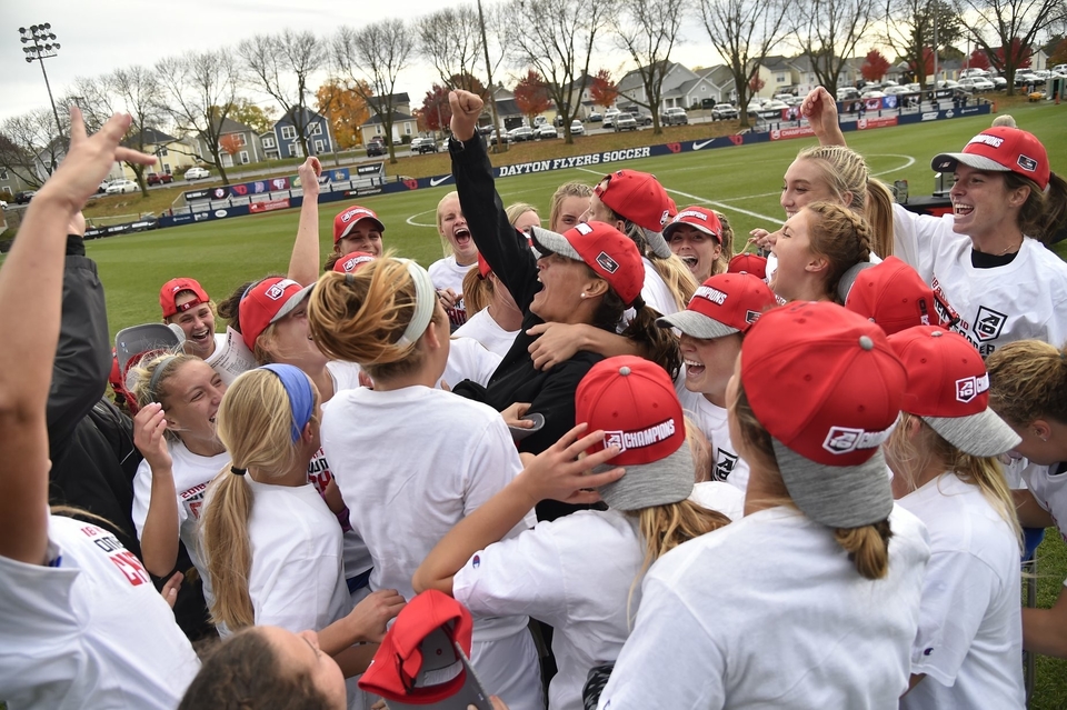 Coach Katie Shields (center) celebrates with her Billikens after winning the 2019 Atlantic 10 Conference Championship.