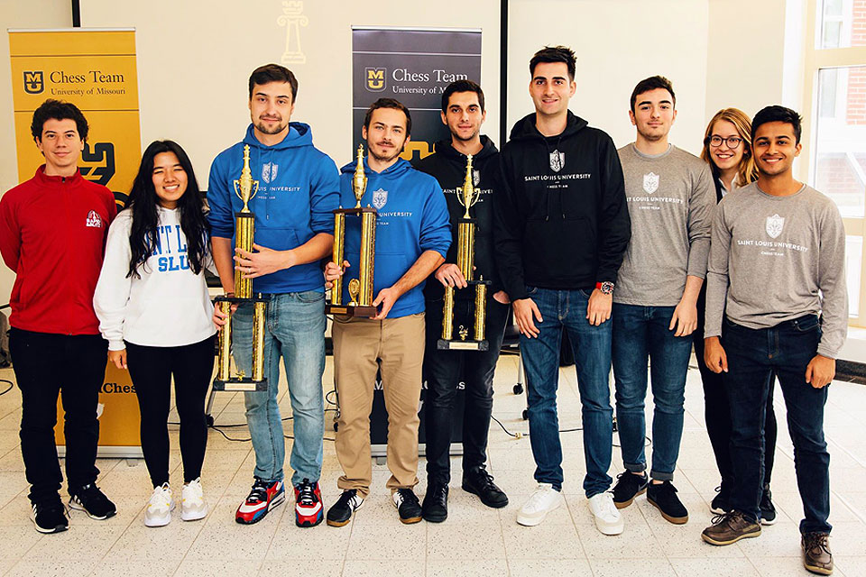 SLU Chess team with trophies at Mizzou