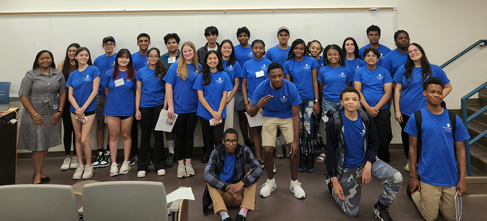Group photo of Summer Scholar Program participants.  Program Director, Fannie Acoff on left and medical students Caroline Wright (second row, right) and Tyric Goode (third row, right). 

