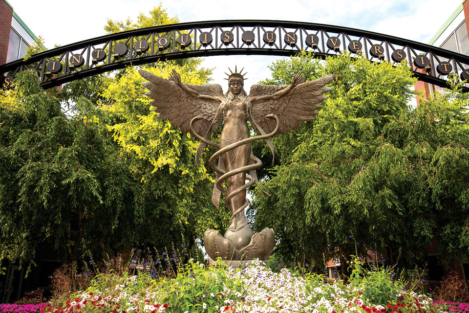 A closeup of the Angel of Mercy statue on the south campus of Saint Louis University. The photo was taken on a sunny day.