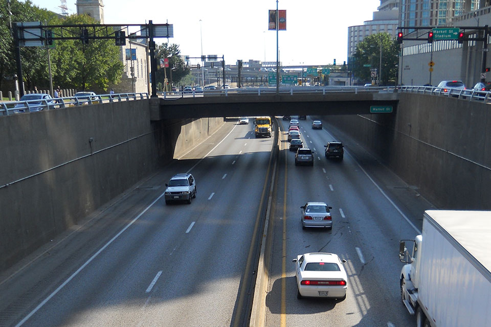 Cars drive on both side of the road on Interstate 44 in downtown St. Louis.