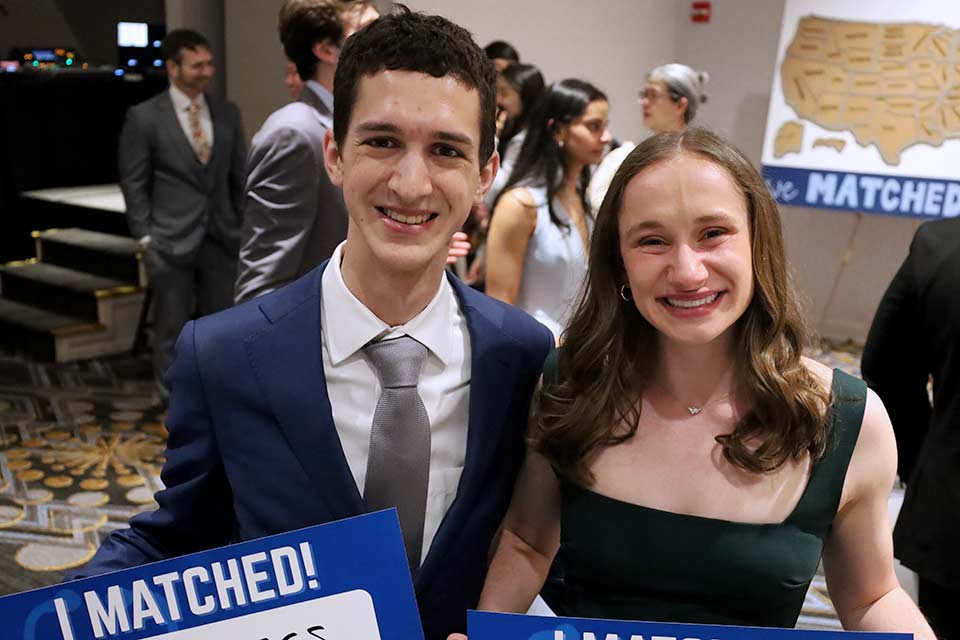 Photo of Joey and Erin Talarico holding their Match Day signs