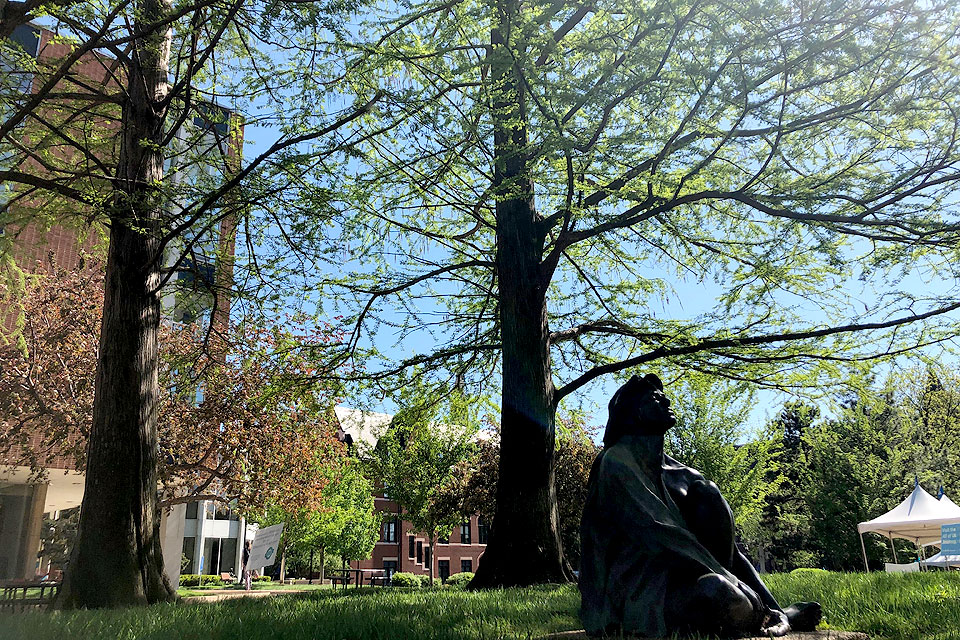 A view of a seated statue near the Pius XII Memorial Library.