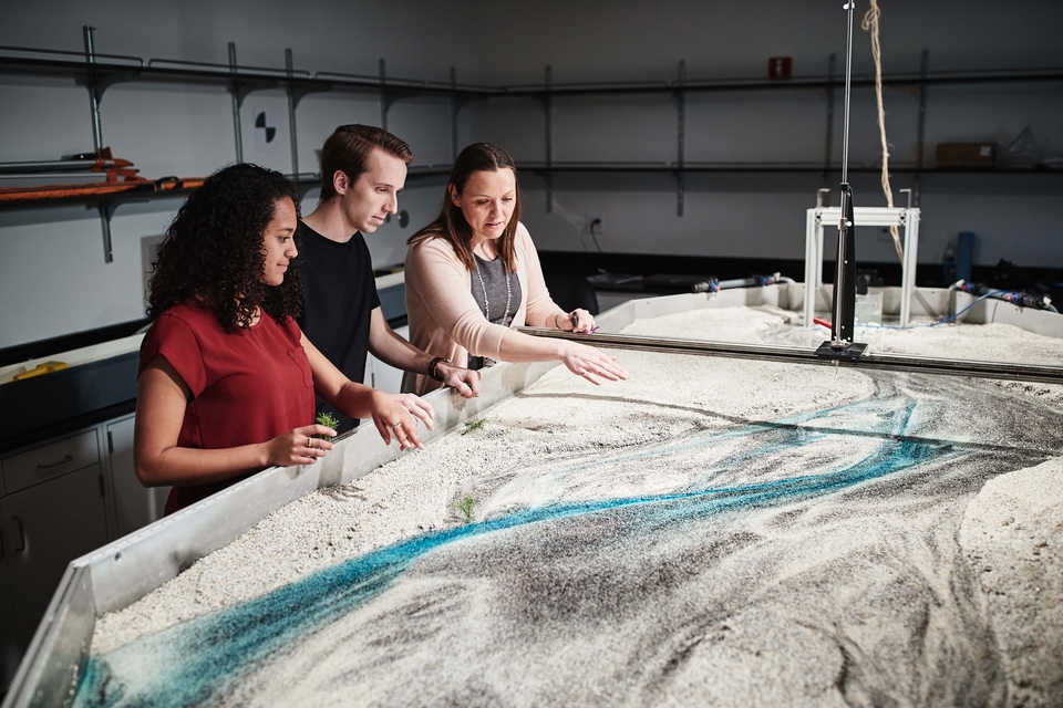 (Far right) Amanda Cox, Ph.D., director of the newly launched WATER Institute, works with students examining a water flow model. SLU photo
