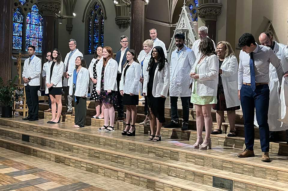 A group of new Saint Louis University School of Medicine students receive their white coats. 