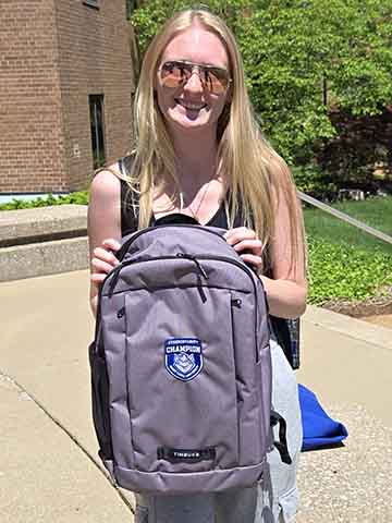 a woman holding a backpack