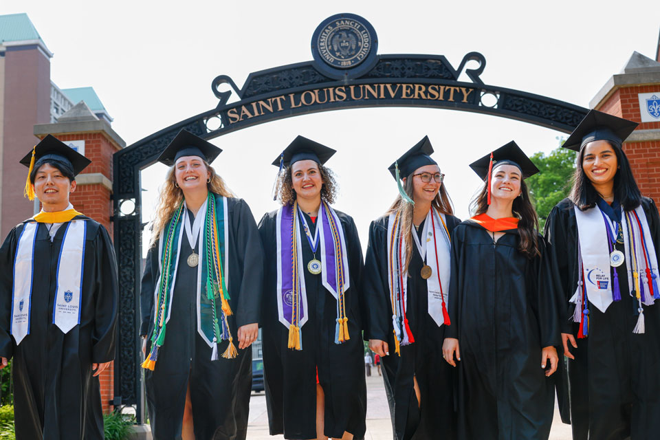 Class of 2022 SLU graduates in caps and gowns on SLU's campus