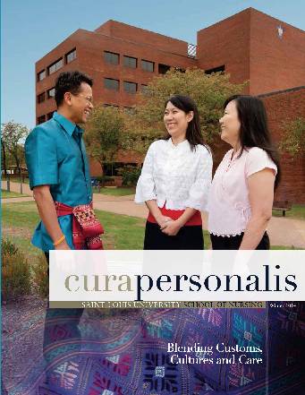 The 2014 cover of cura personlis showing three nursing students in front of the nursing school