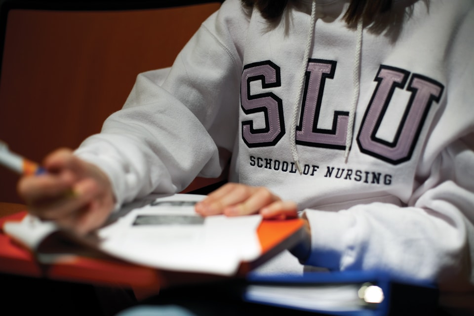 Upclose photo of SLU nursing student taking notes