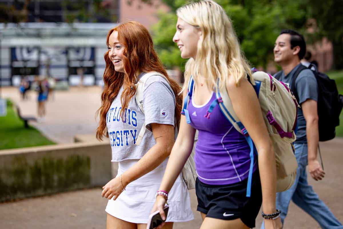 Two students walk on campus