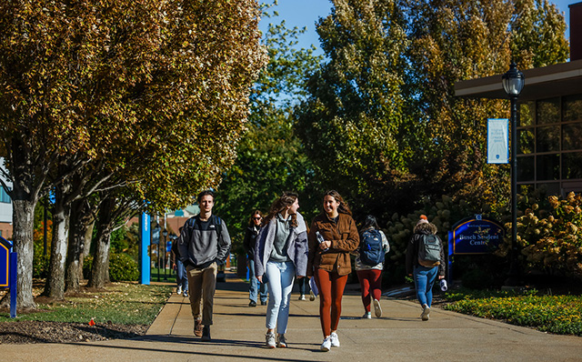 Students walking through campus in the fall