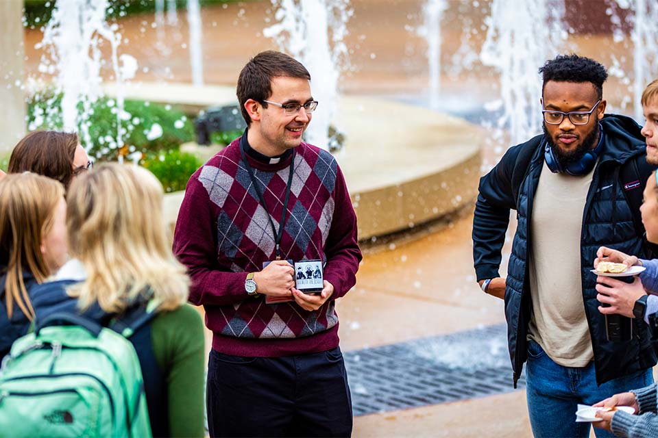 A Jesuit Scholastic shares coffee with SLU Students during a Java with the Jesuits session.