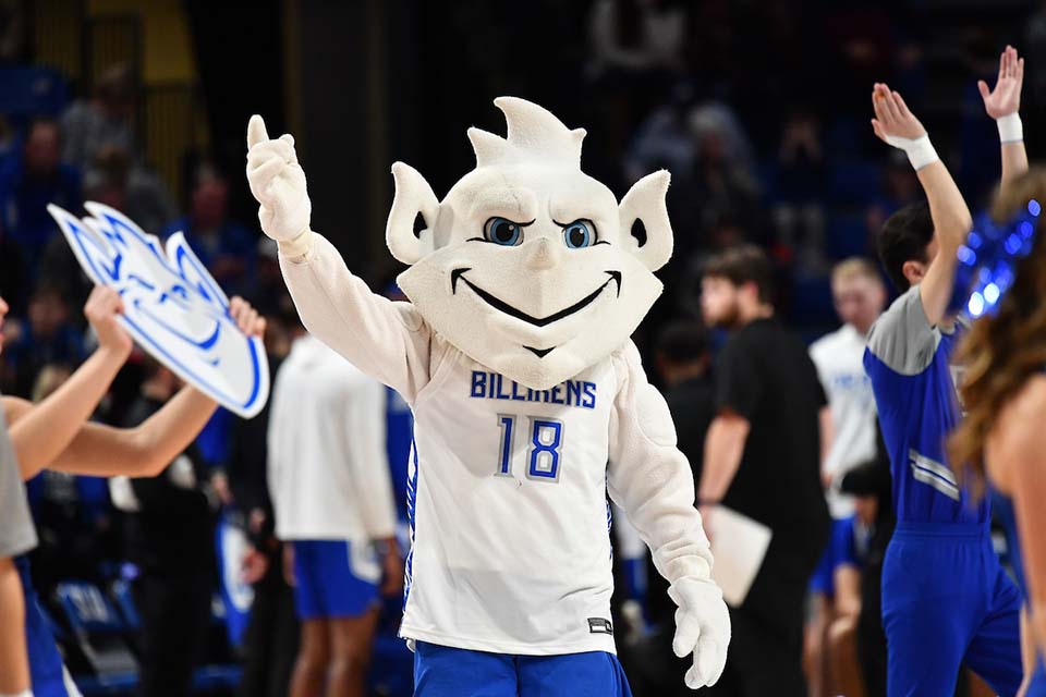Billiken Mascot outside inside a game at Chaifetz Arena with his arm raised