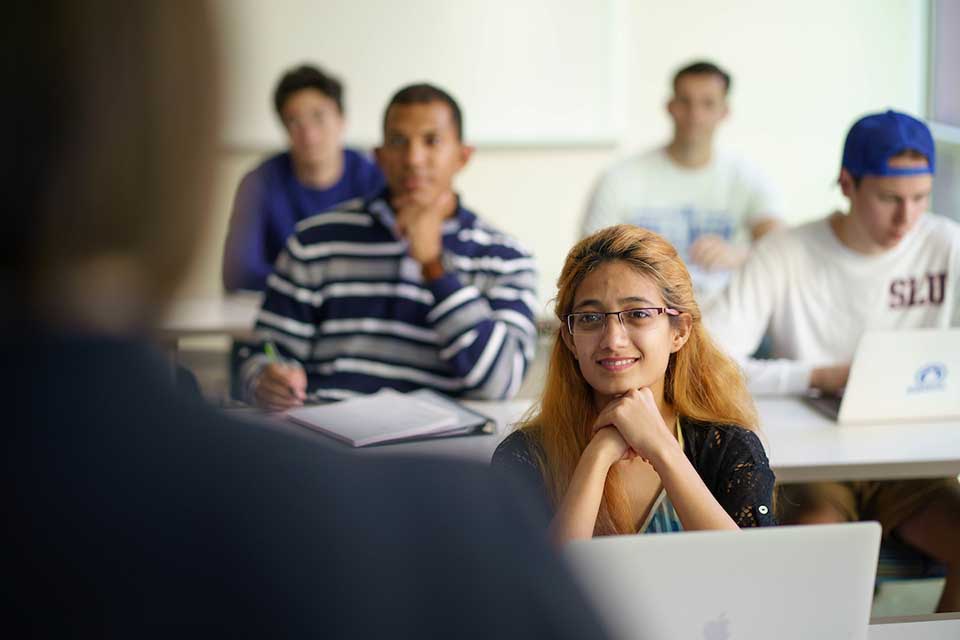A classroom of students listens attentively to a lecture