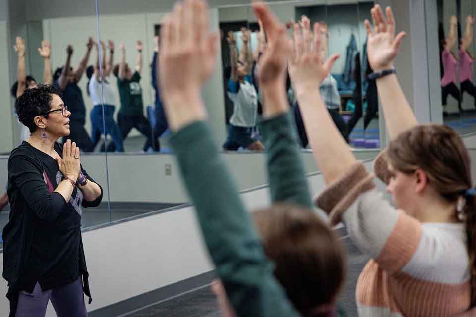 Students practice a yoga flow