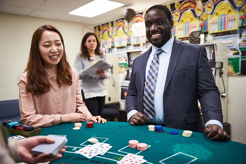 Woman observing man and woman in gambling lab