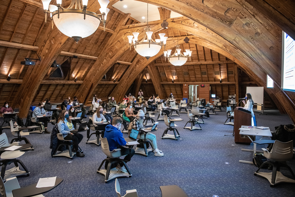 Dr. Anne Sebert-Kuhlmann teaching in beautiful top floor classroom with large wooden beams in DuBourg Hall 