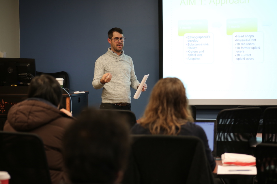 Matthew Ellis gives a presentation on his opioid research to classmates.