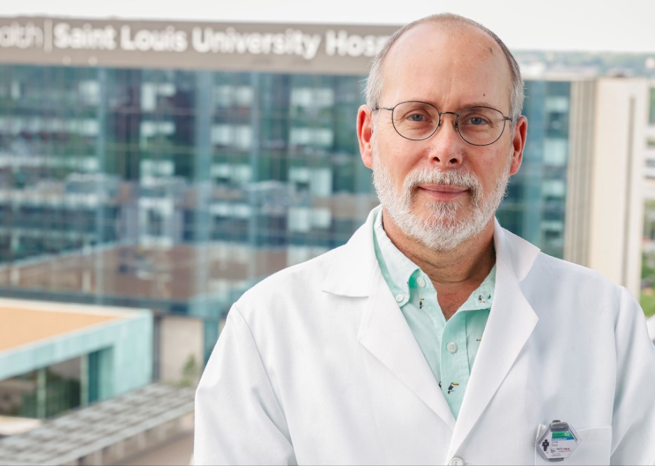 A headshot of John Tavis, Ph.D., in a white lab coat John Tavis, Ph.D.