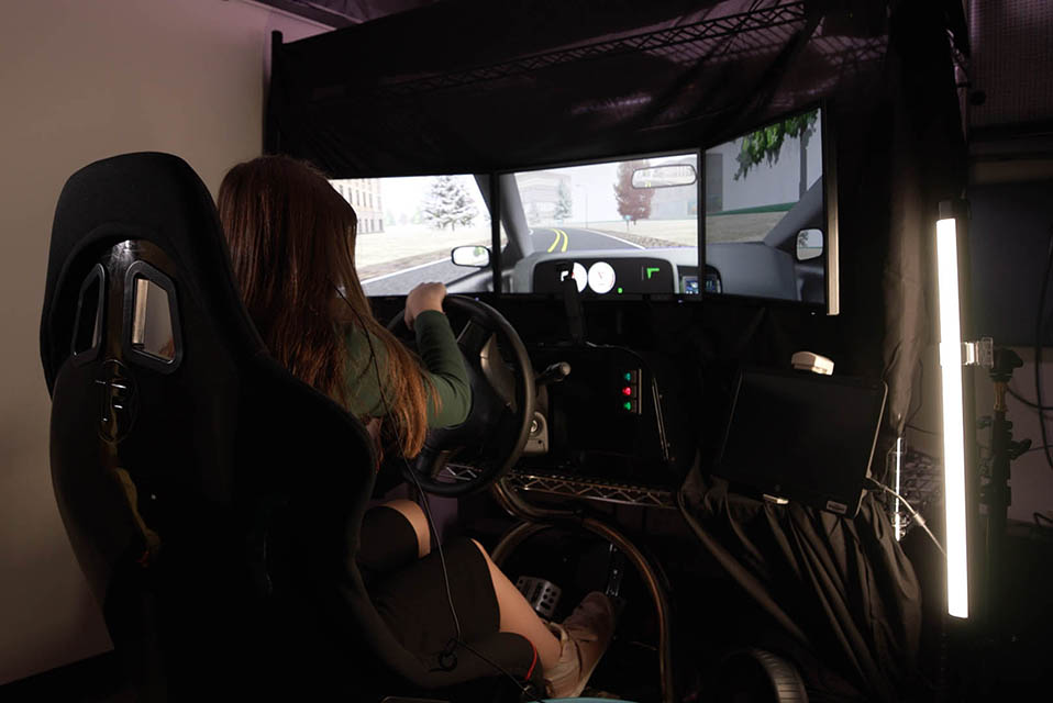 Teen participating in driving simulation training and assessments.