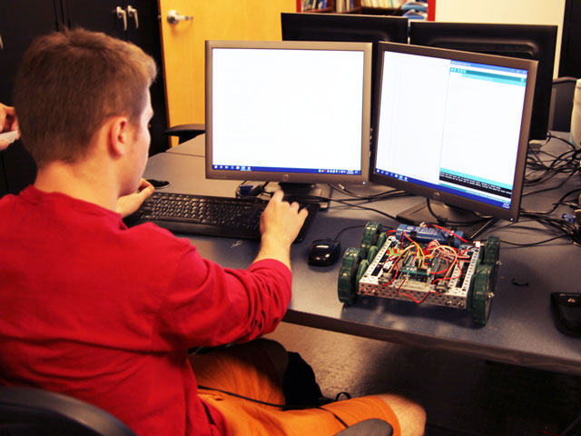 Student working on robotics project at summer camp