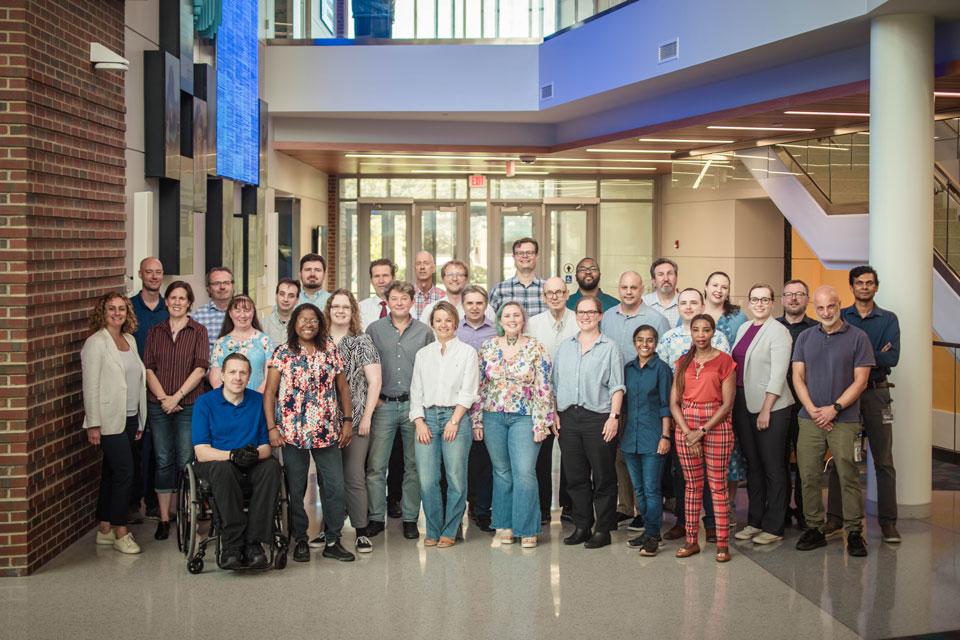 Group photo showing SLU chemistry faculty standing in an atrium