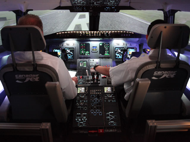 Two students in a flight simulator