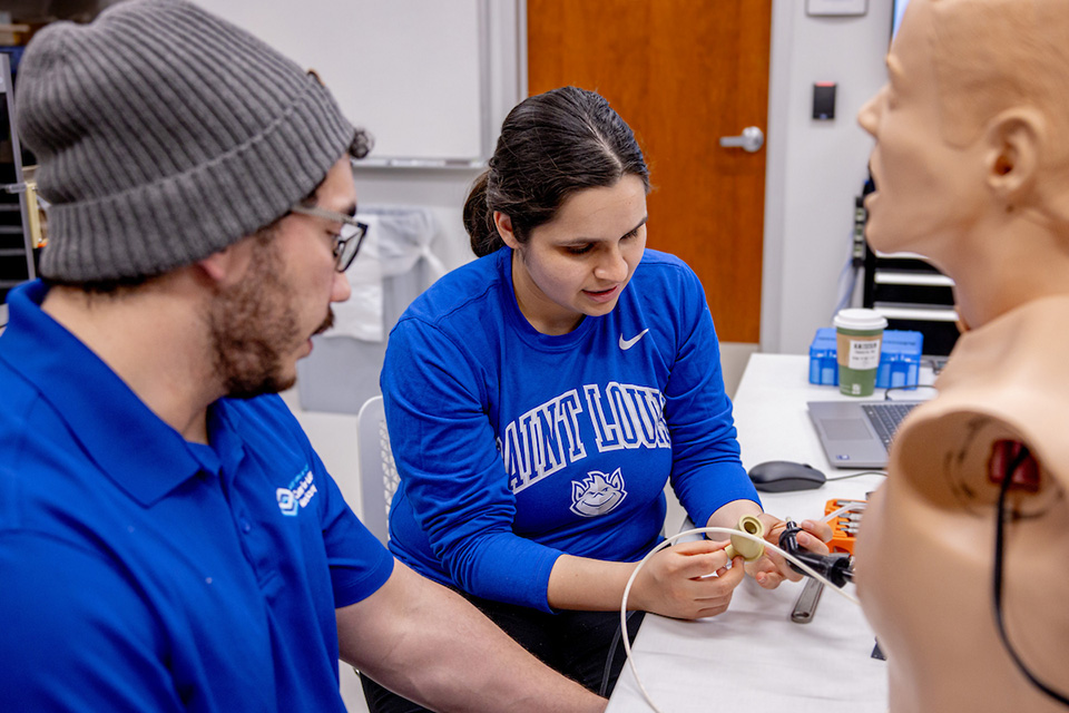 Two people work at a desk in the Center for Additive Manufacturing