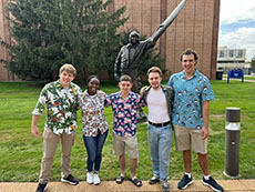 Project HEAT group members pictured outside in front of a statue
