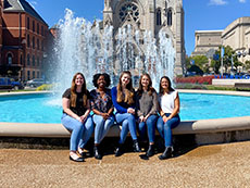 Group of students posed outside near a fountain