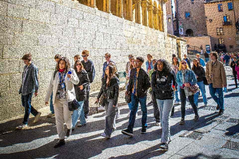 A group of SLU students participate in a walking tour in during a study abroad trip.